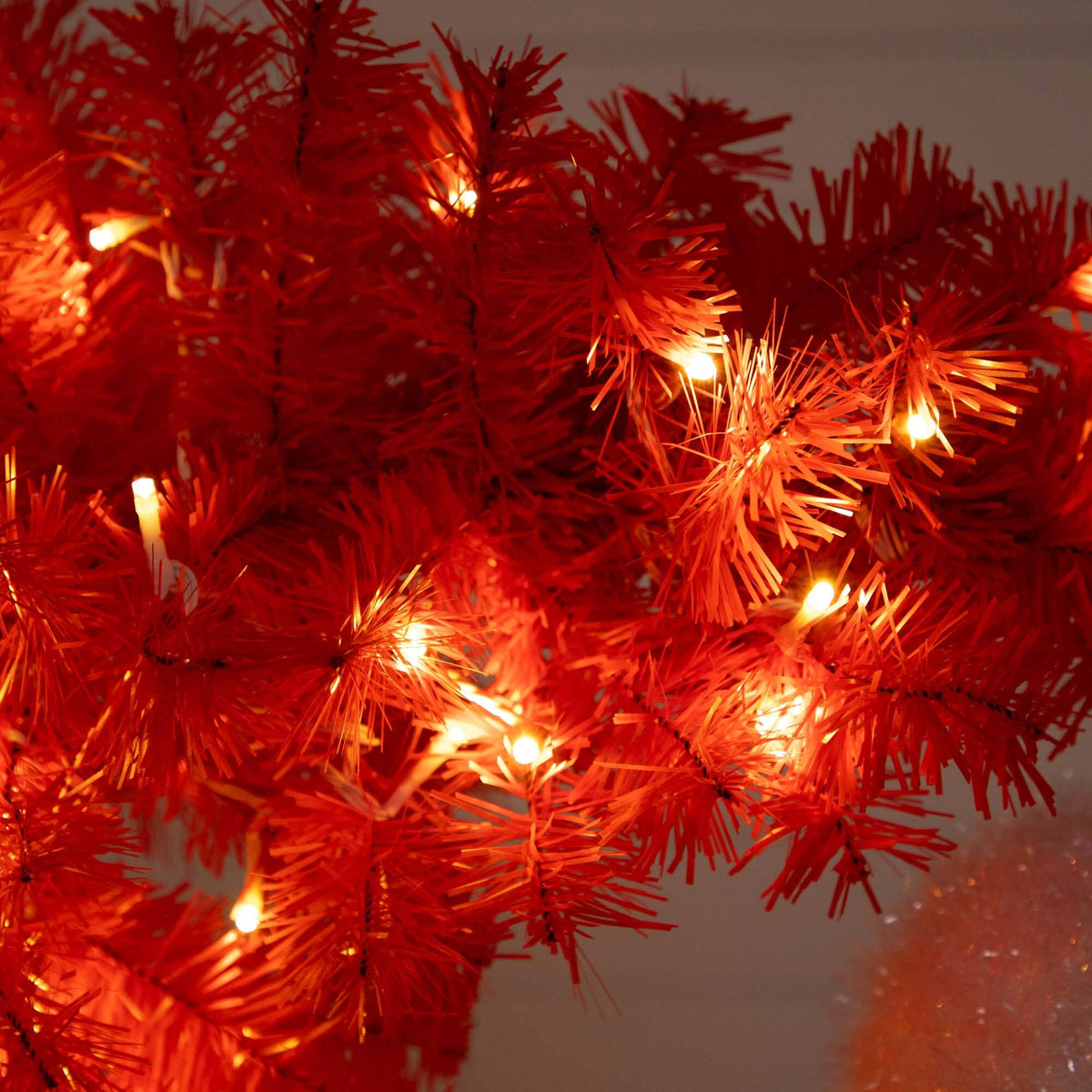 a red tree with lights