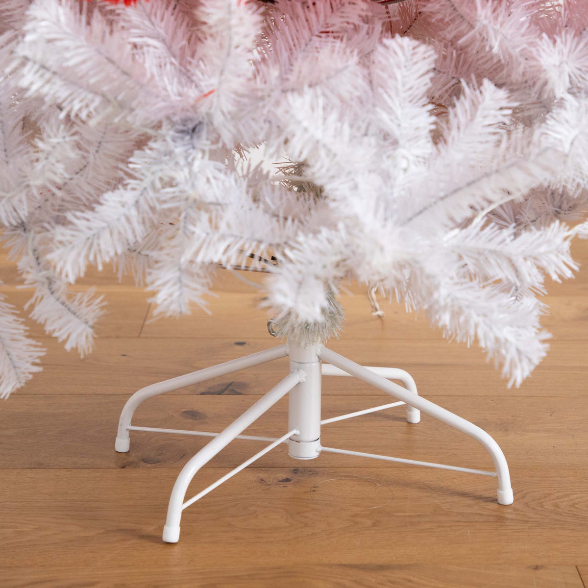 a white christmas tree with a white base