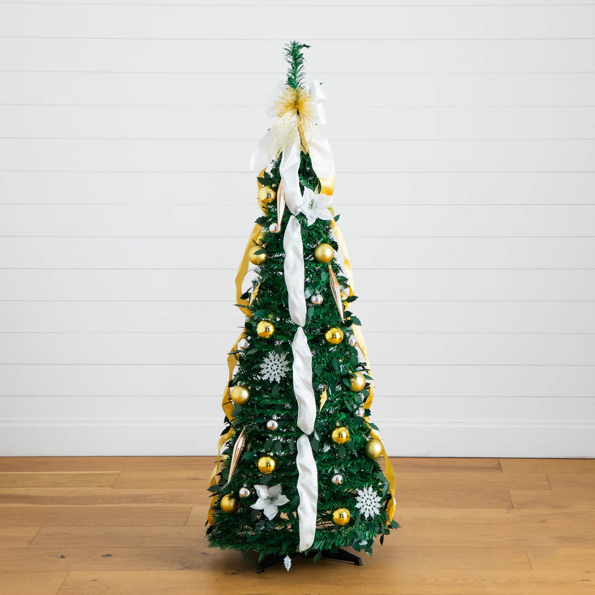 a christmas tree with ornaments and ribbons