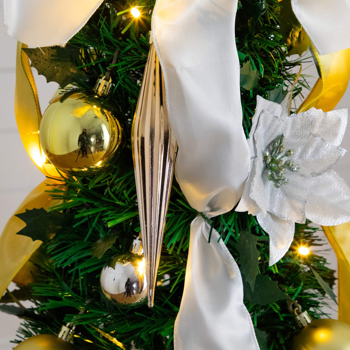 a christmas tree with ornaments and ribbons