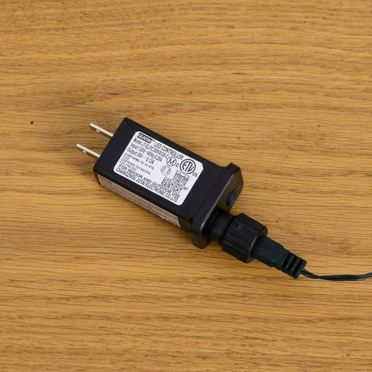 a black electrical device with a wire