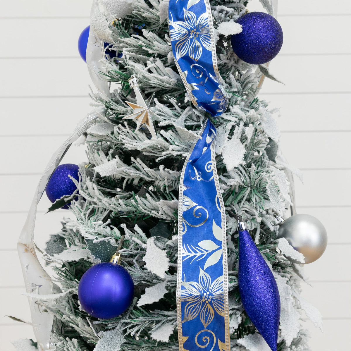 a christmas tree with blue and silver ornaments