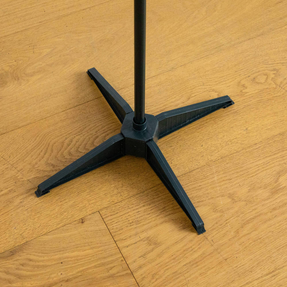 a black pole on a wood floor