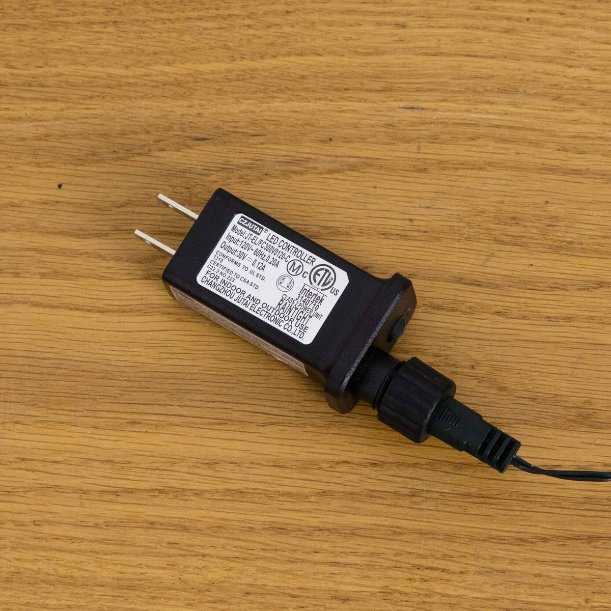 a black electrical device with a wire