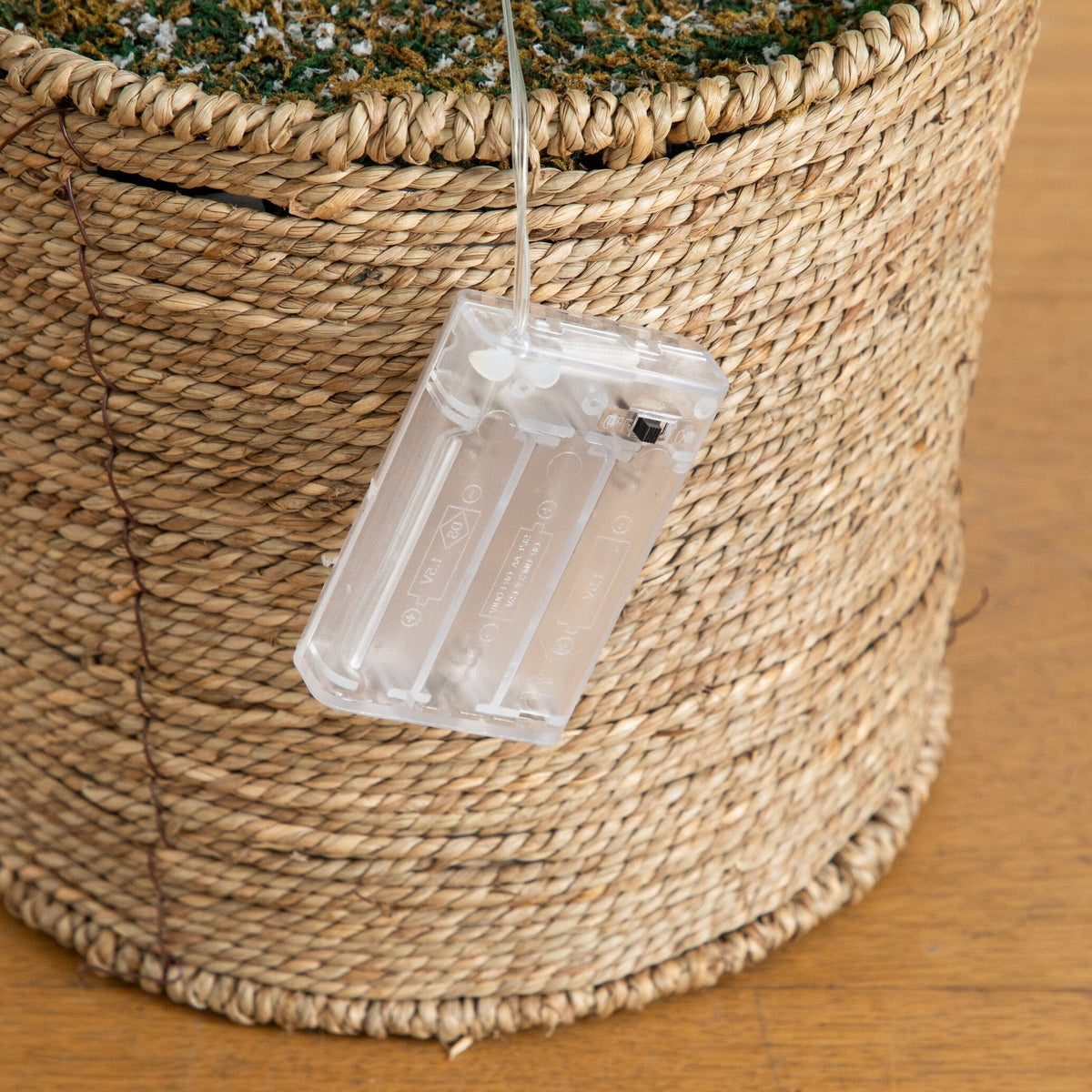 a basket with a plastic container attached to it