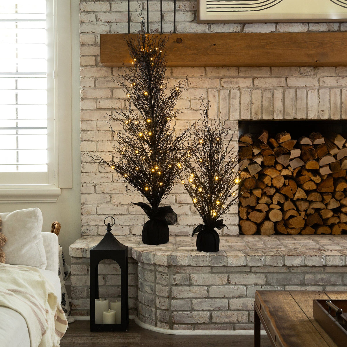a fireplace with lights and a bed