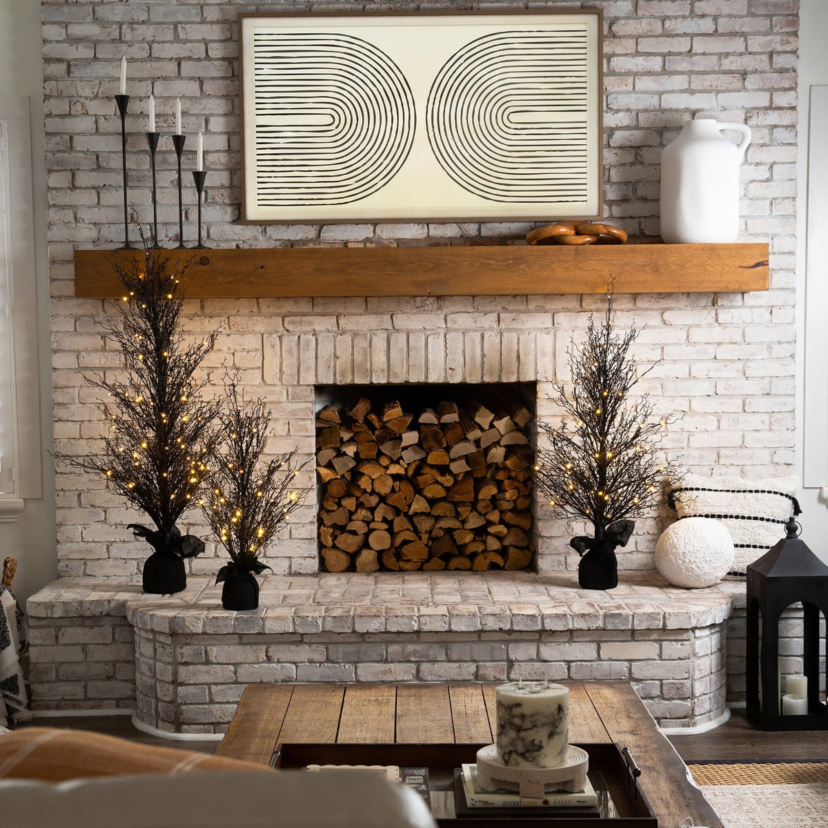a fireplace with a wood shelf and a painting on the wall