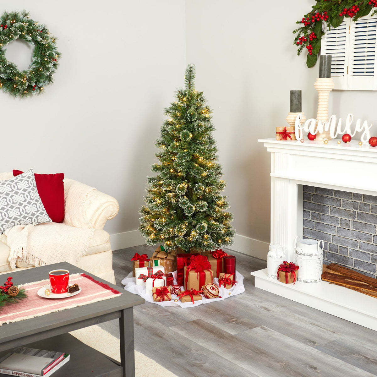 a christmas tree with presents around it