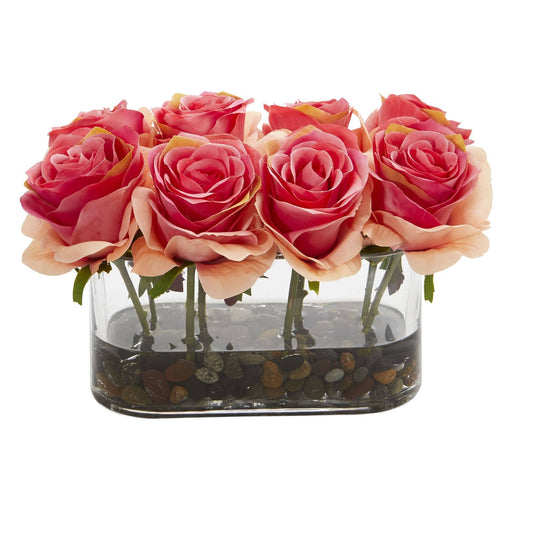 a group of pink roses in a glass vase