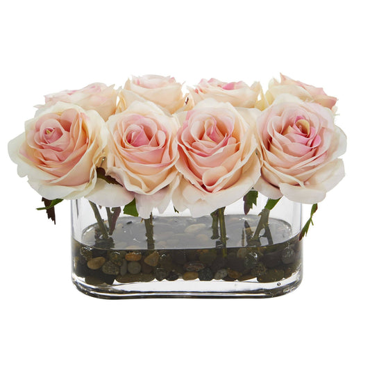 a group of pink roses in a glass vase