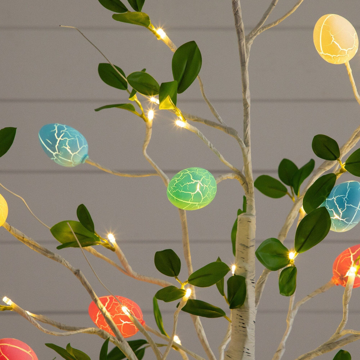 a tree with lights and eggs