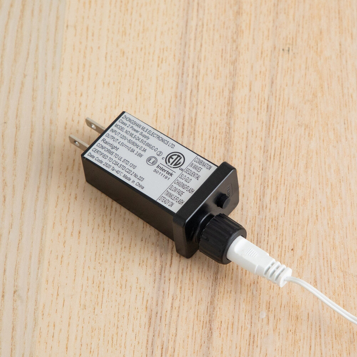 a black and white charger with a white cord