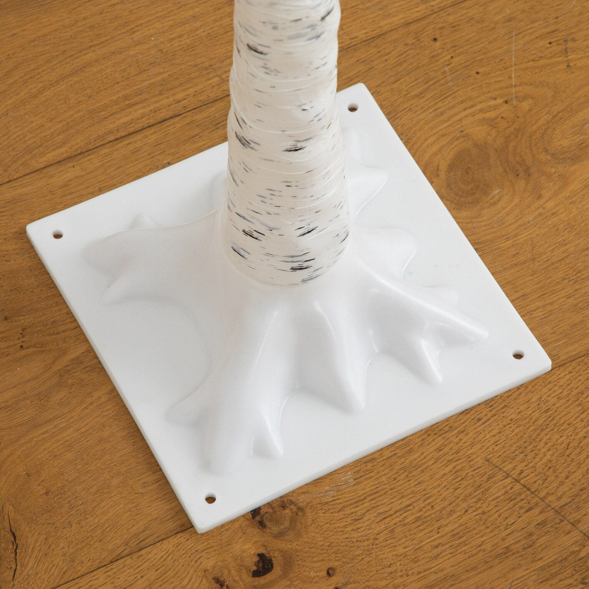 a white plastic base with a white pole