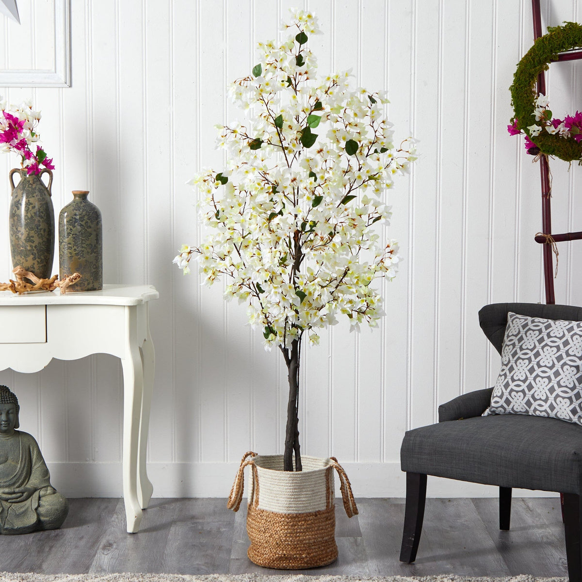 a tree in a basket next to a chair and a table
