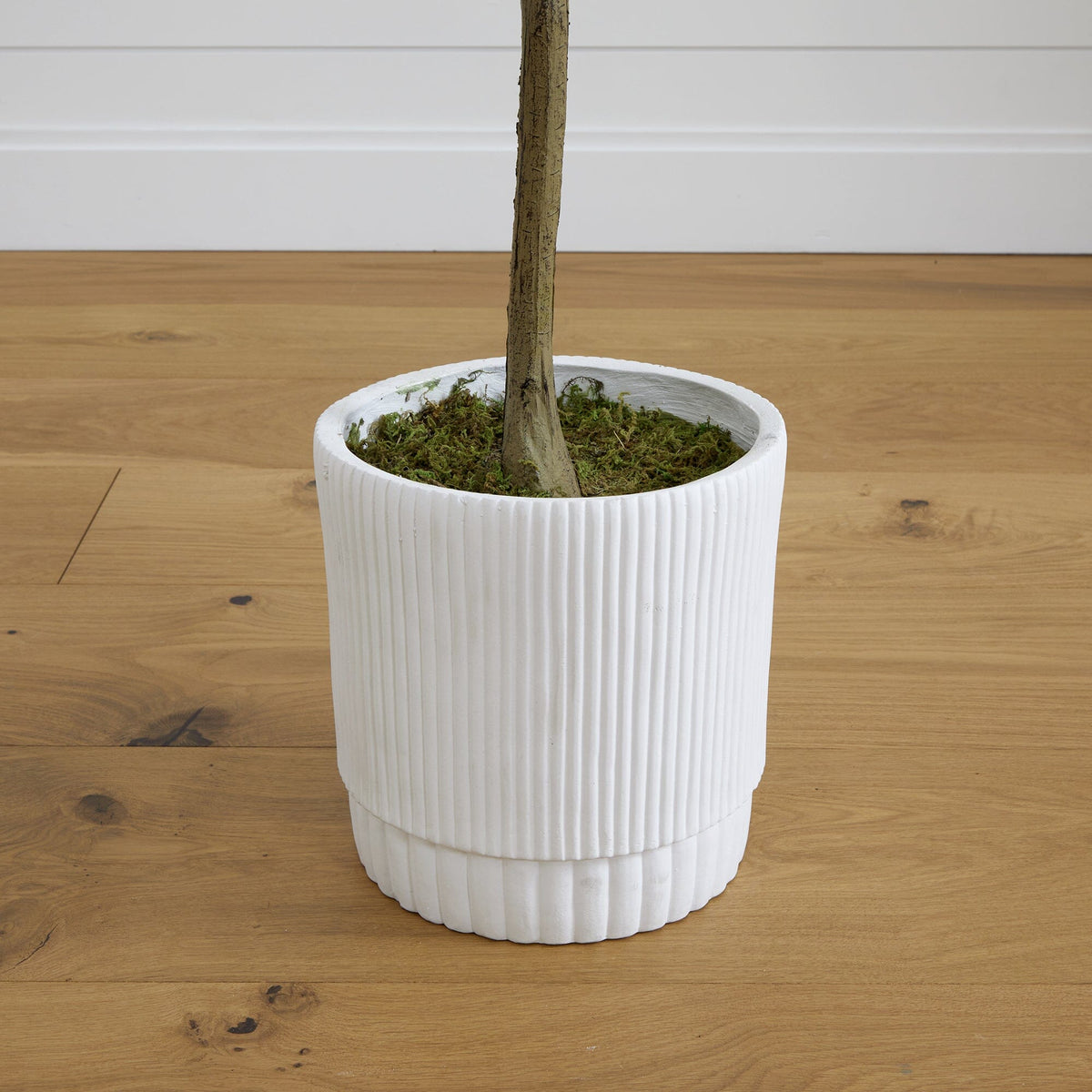 a white pot with a stem in it