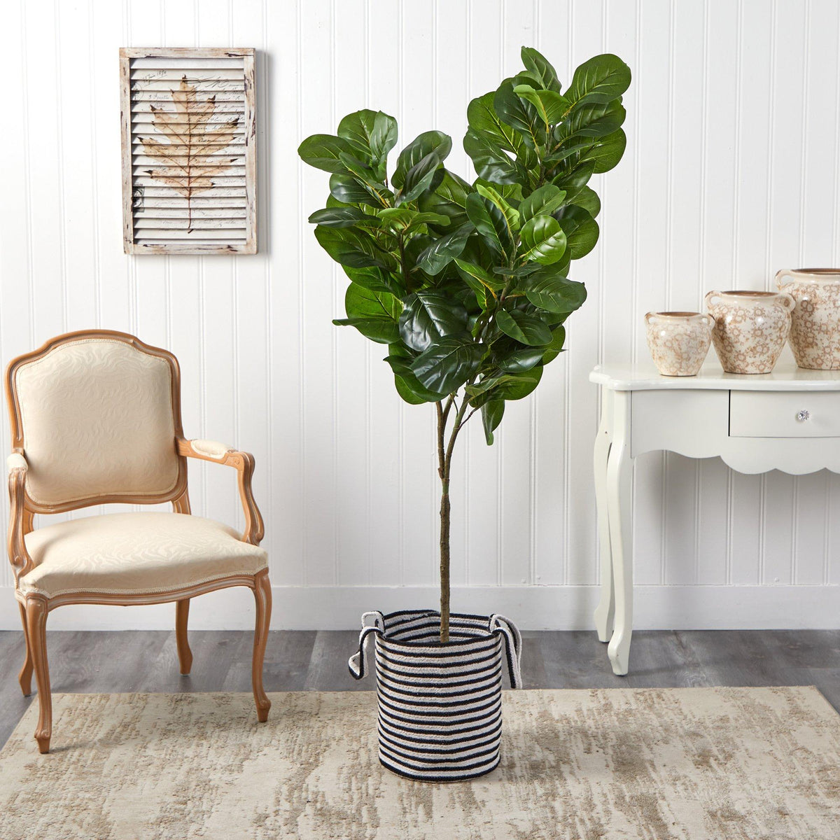 a plant in a pot next to a chair