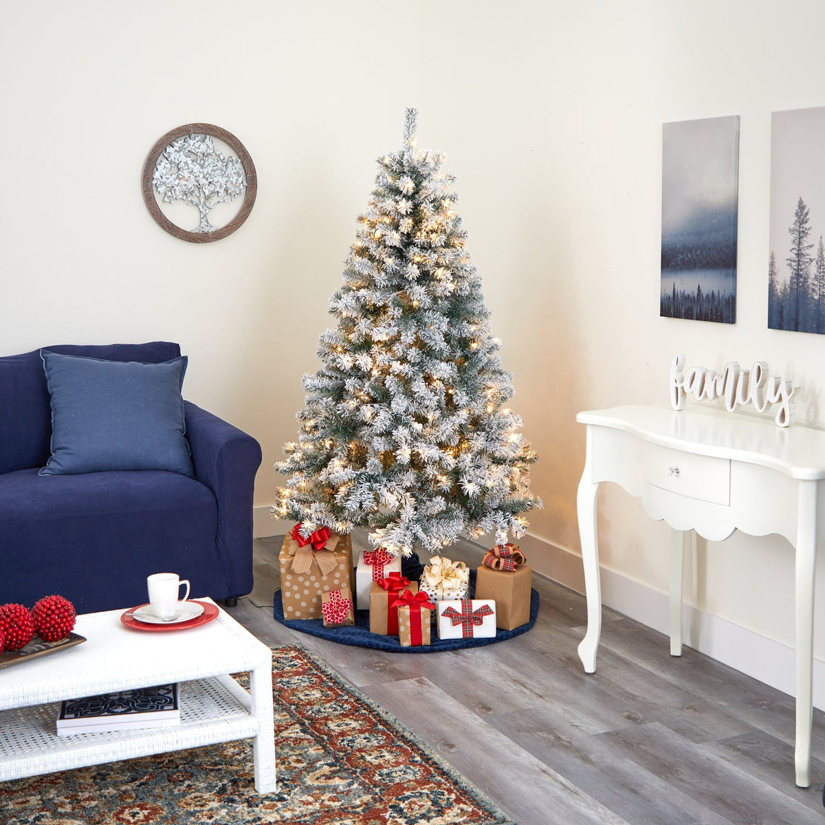 a christmas tree with presents in a room