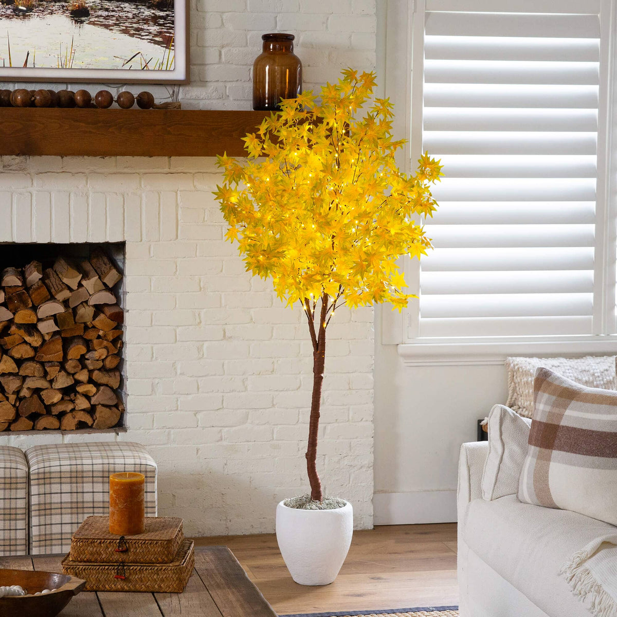 a yellow tree in a white pot in a living room