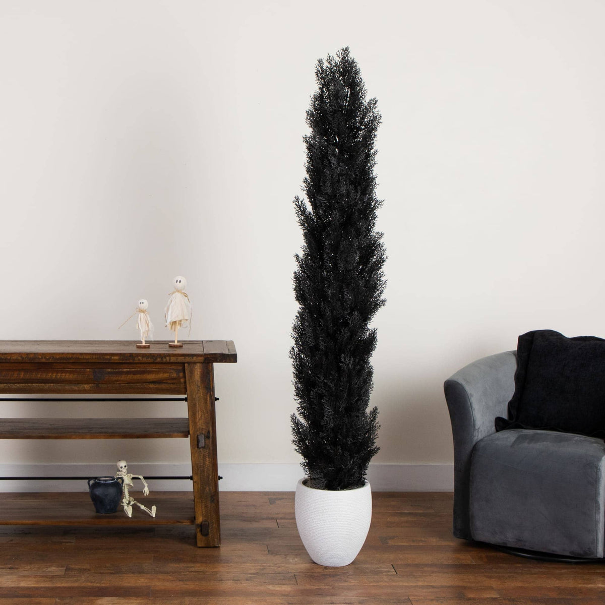 a plant in a white pot next to a wooden table