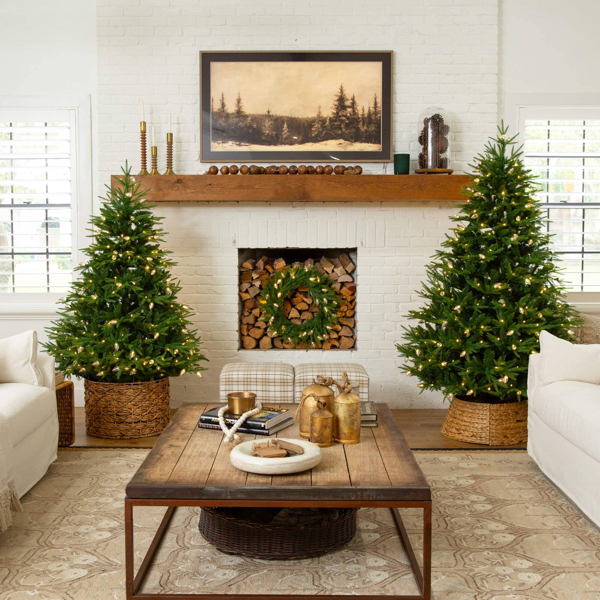 a living room with christmas trees and a fireplace