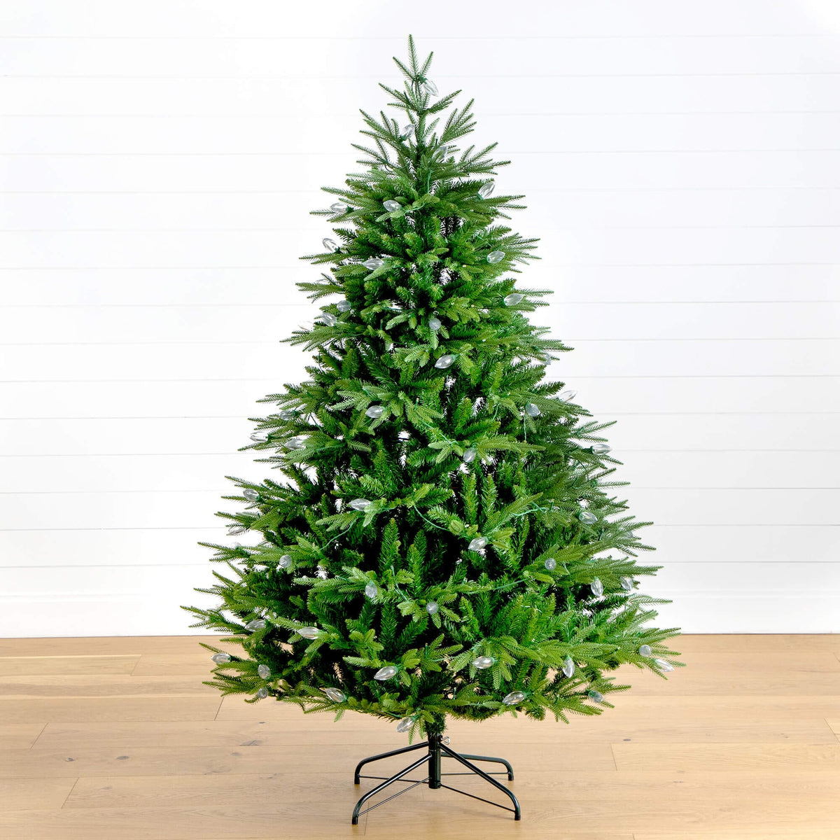 a christmas tree on a wood floor