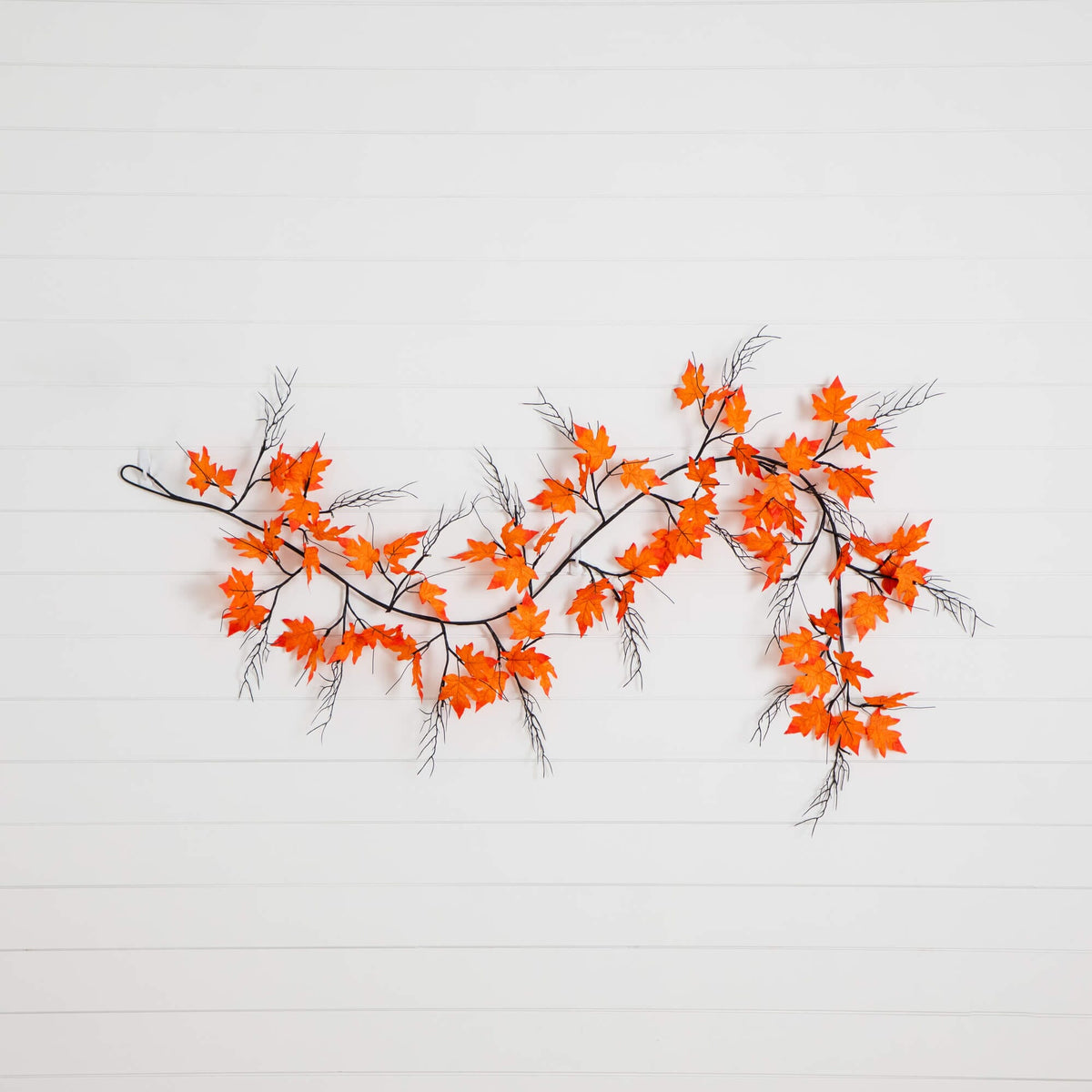 a branch with orange leaves on it