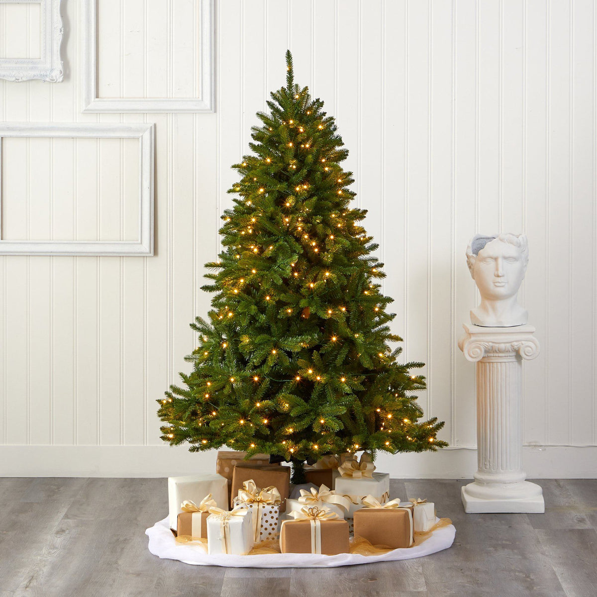 a christmas tree with presents on a white surface