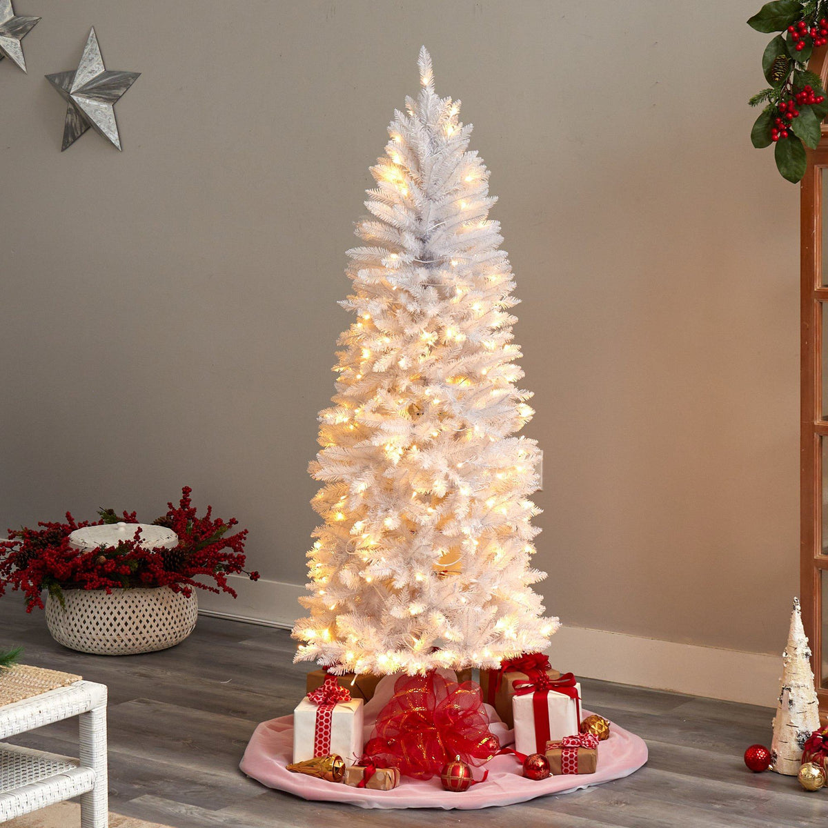 a white christmas tree with lights and presents