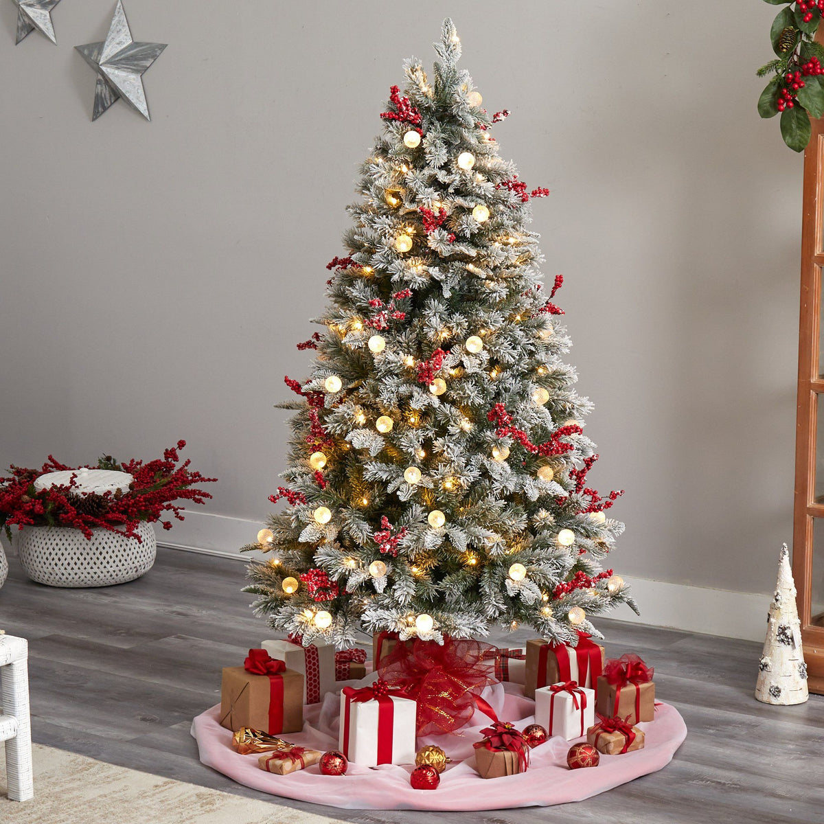 a christmas tree with presents on a rug