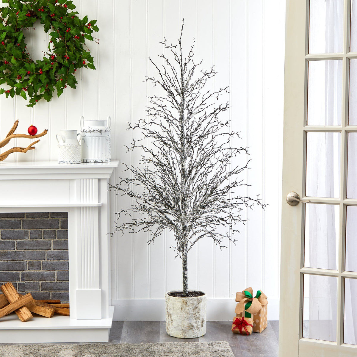 a tree in a pot next to a fireplace