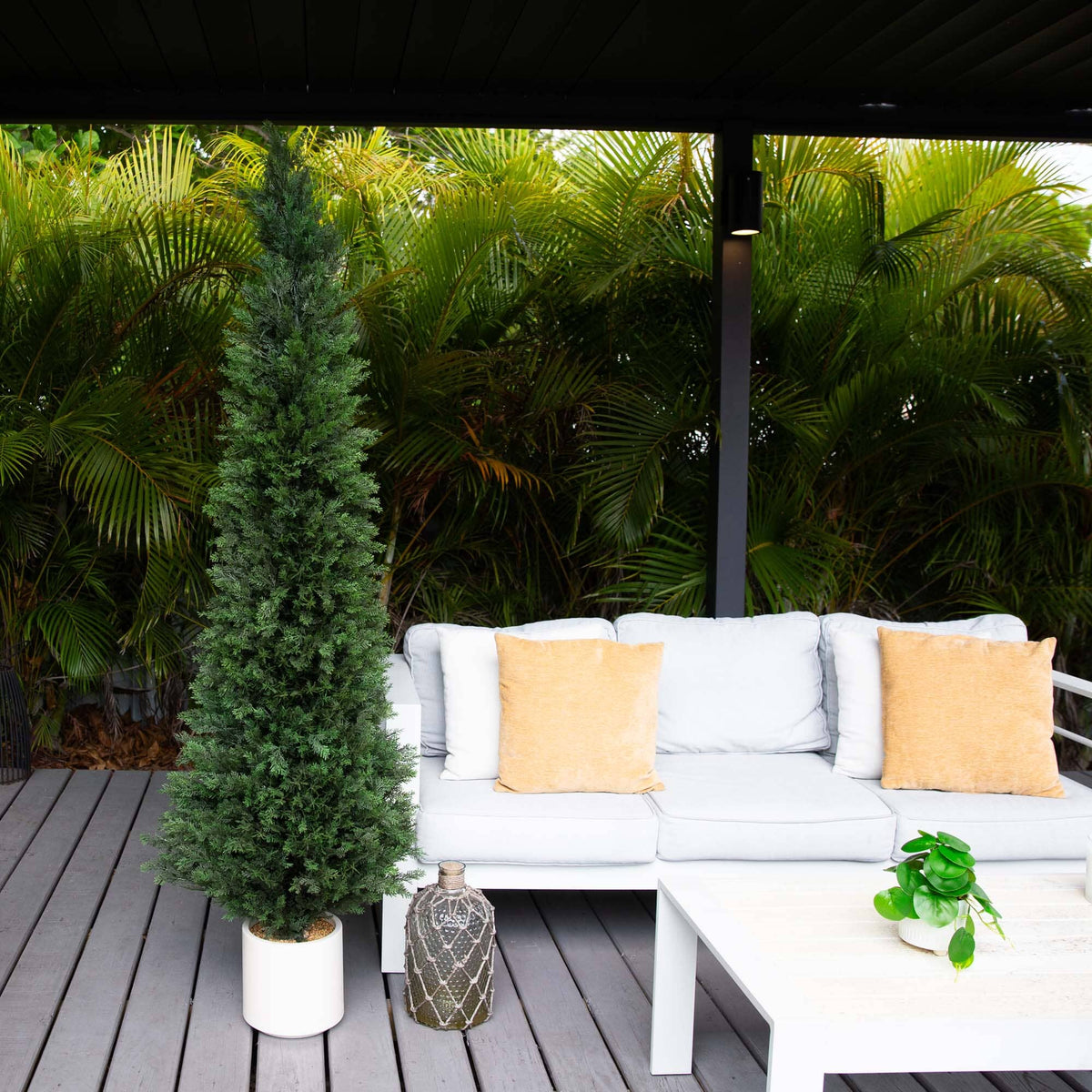 a white couch and a table on a deck