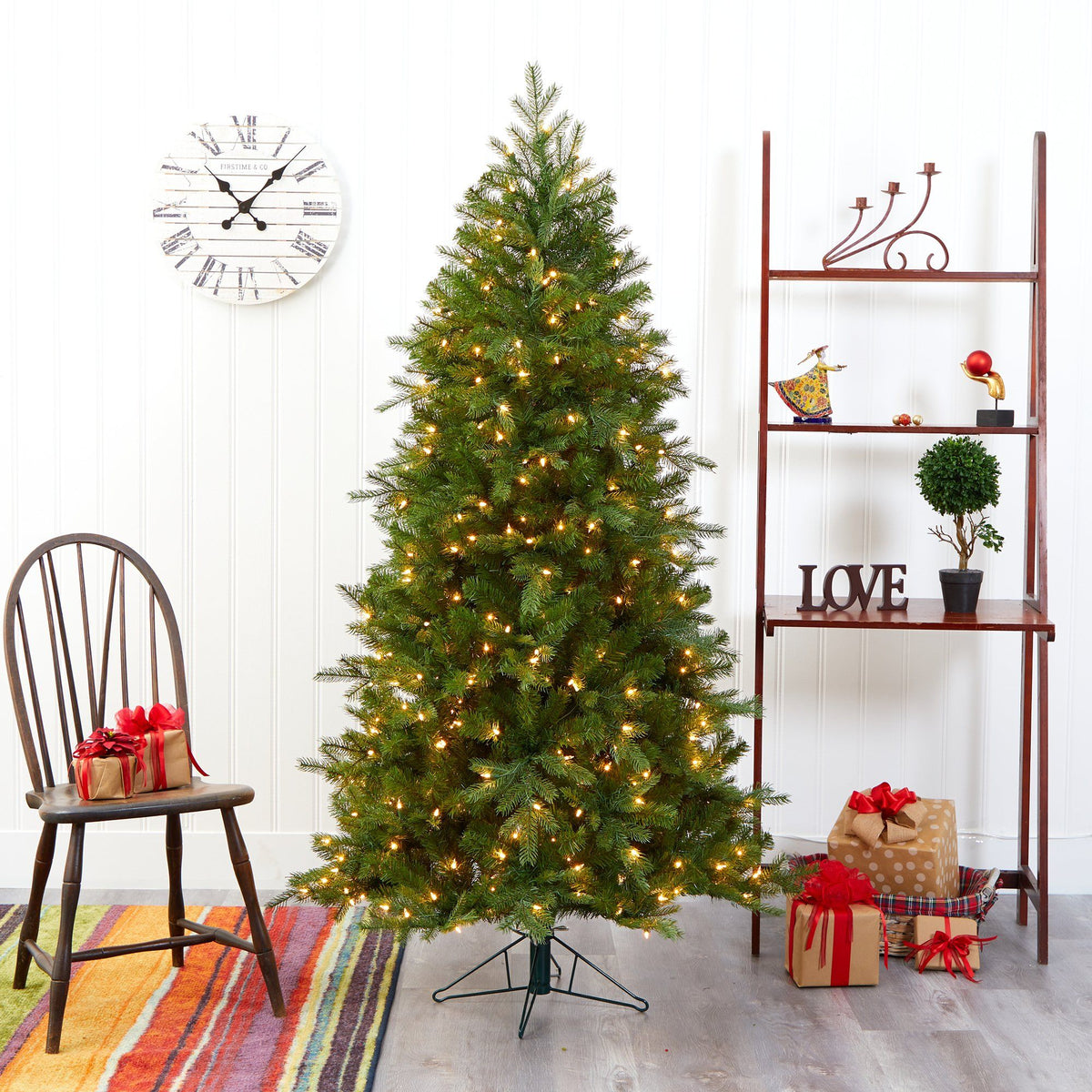 a christmas tree with lights and a chair and a shelf