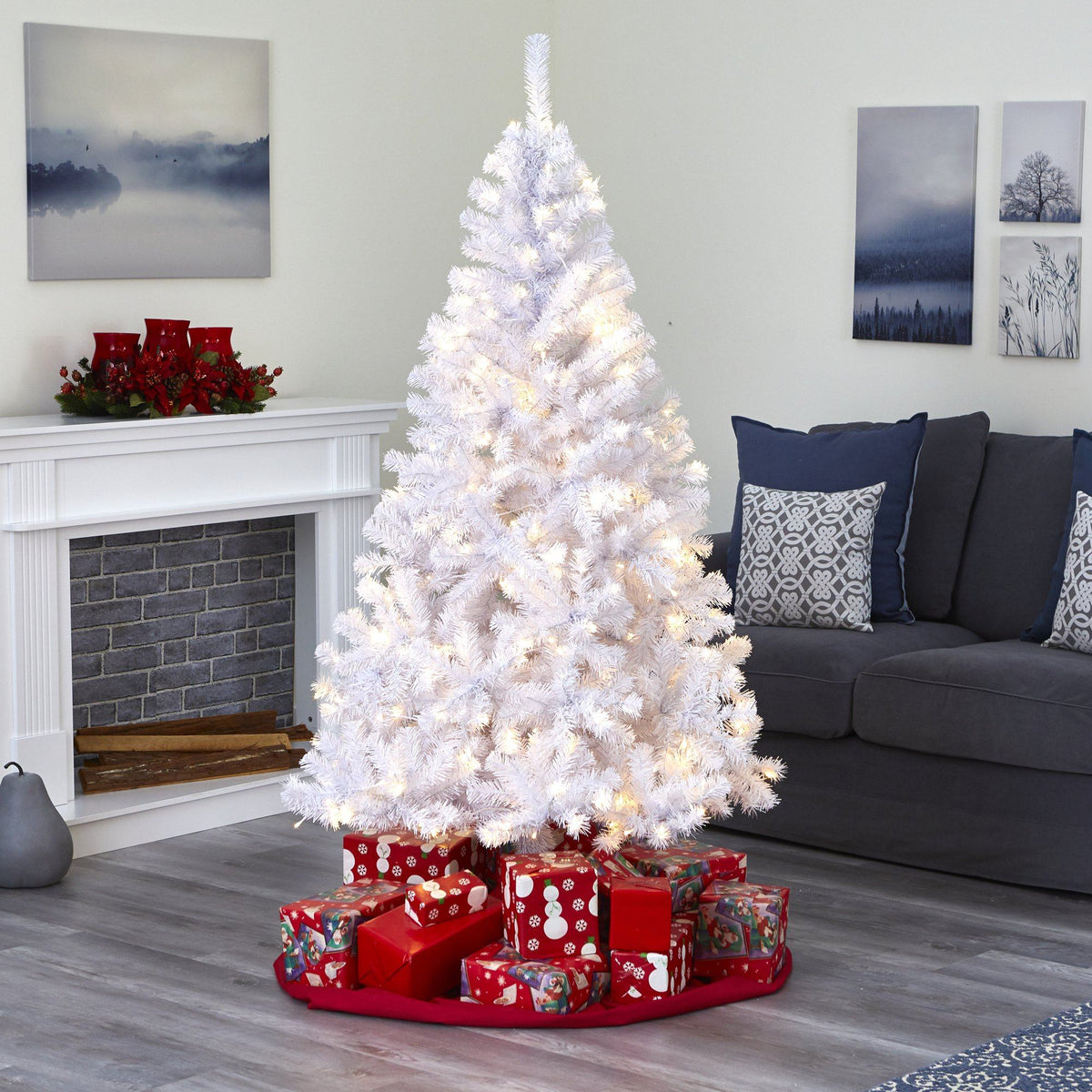a white christmas tree with presents around it