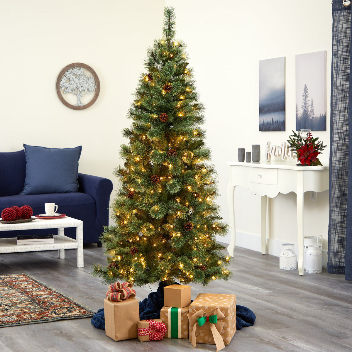 a christmas tree with lights and presents in a living room