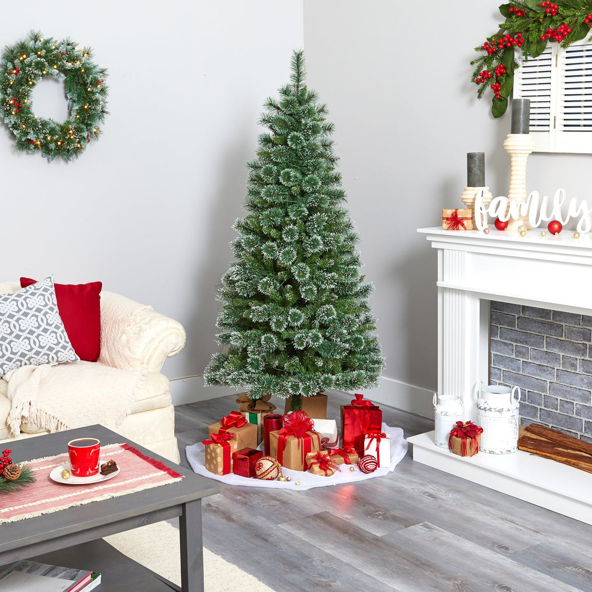 a christmas tree in a room with a fireplace and a couch