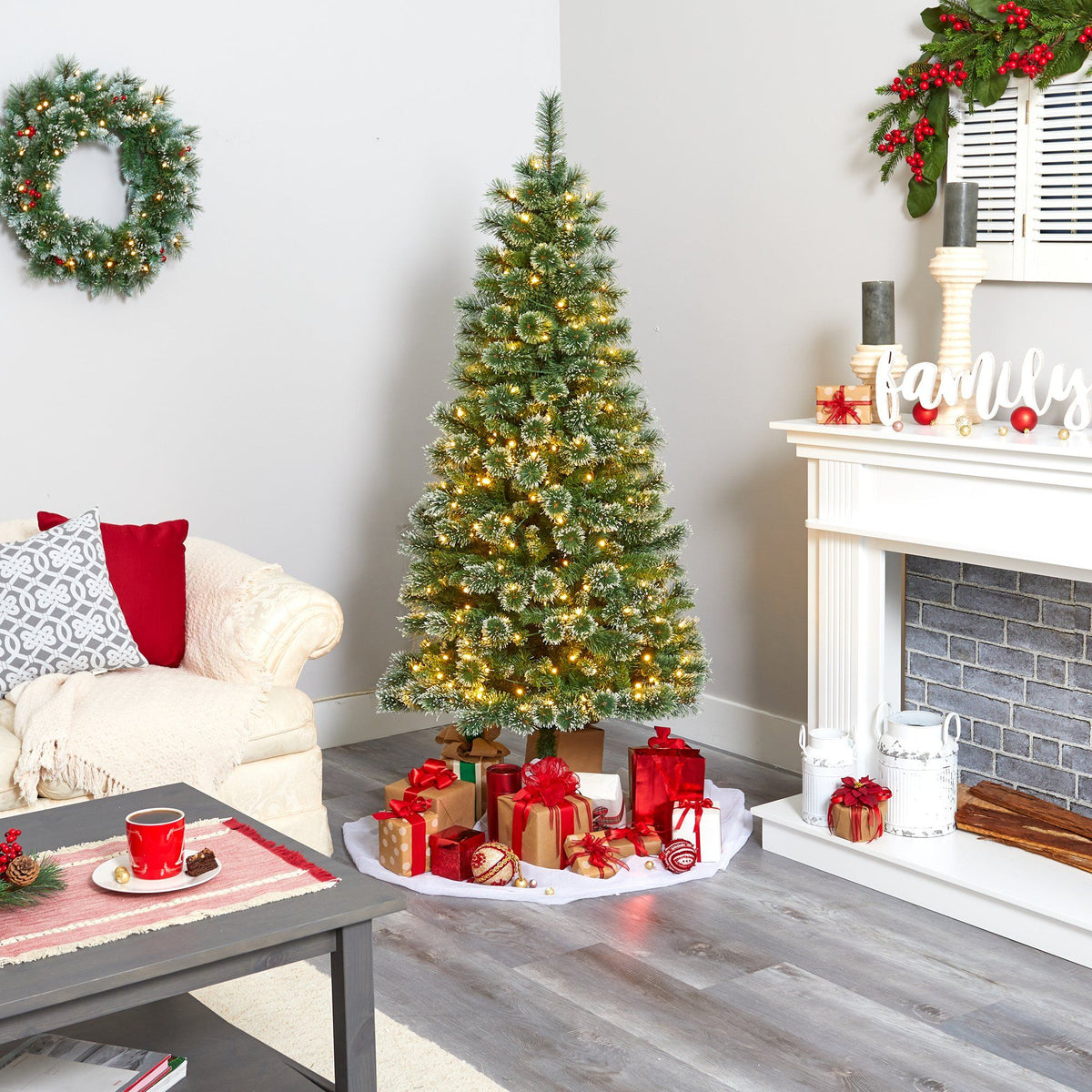 a christmas tree in a room with a fireplace and a couch