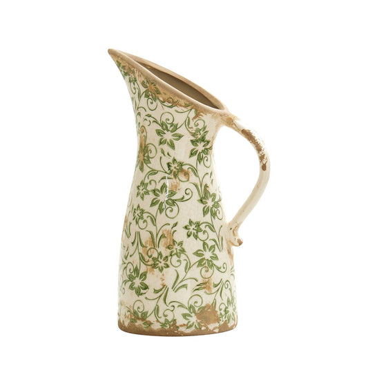 a white and green vase with a handle