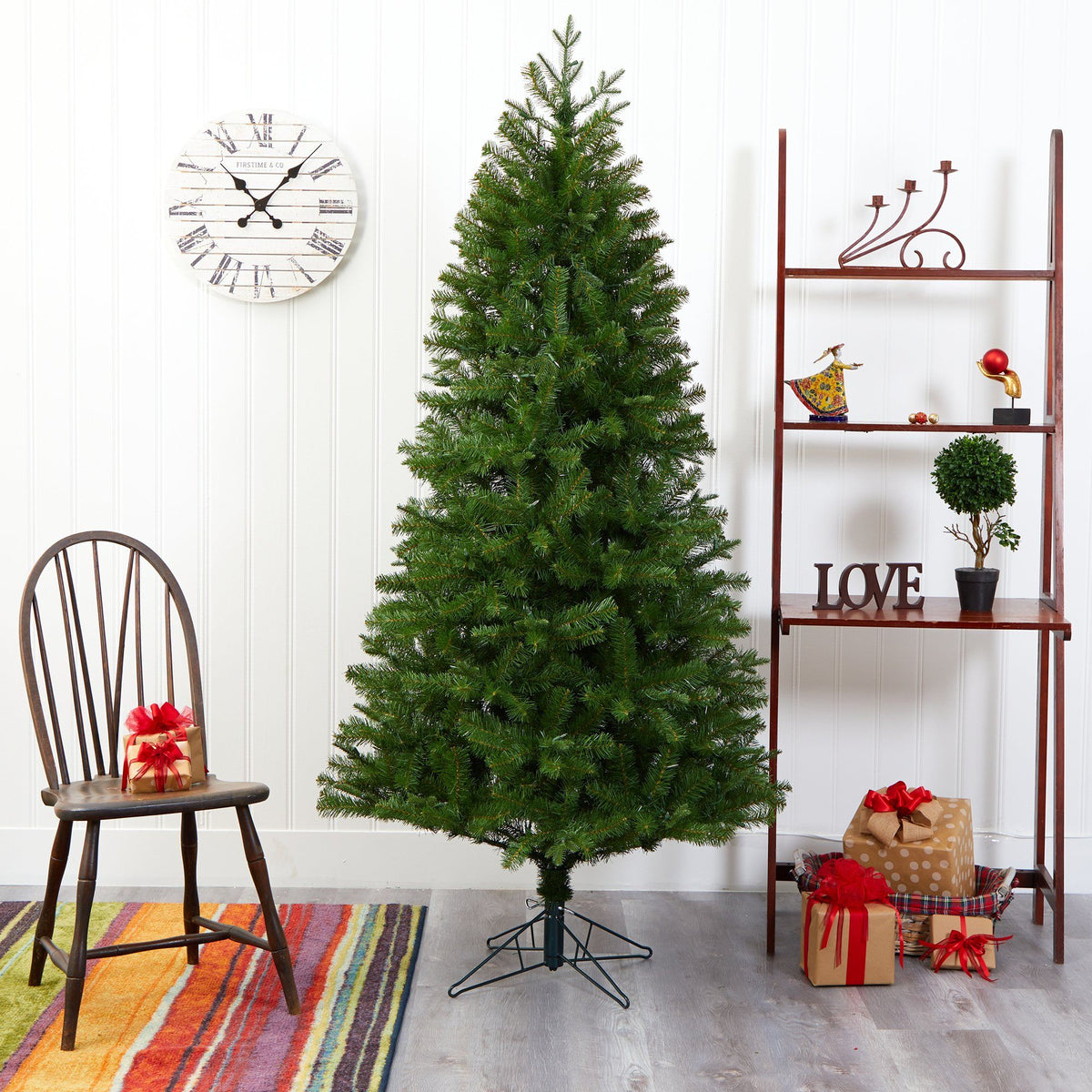 a christmas tree in a room with a chair and a shelf