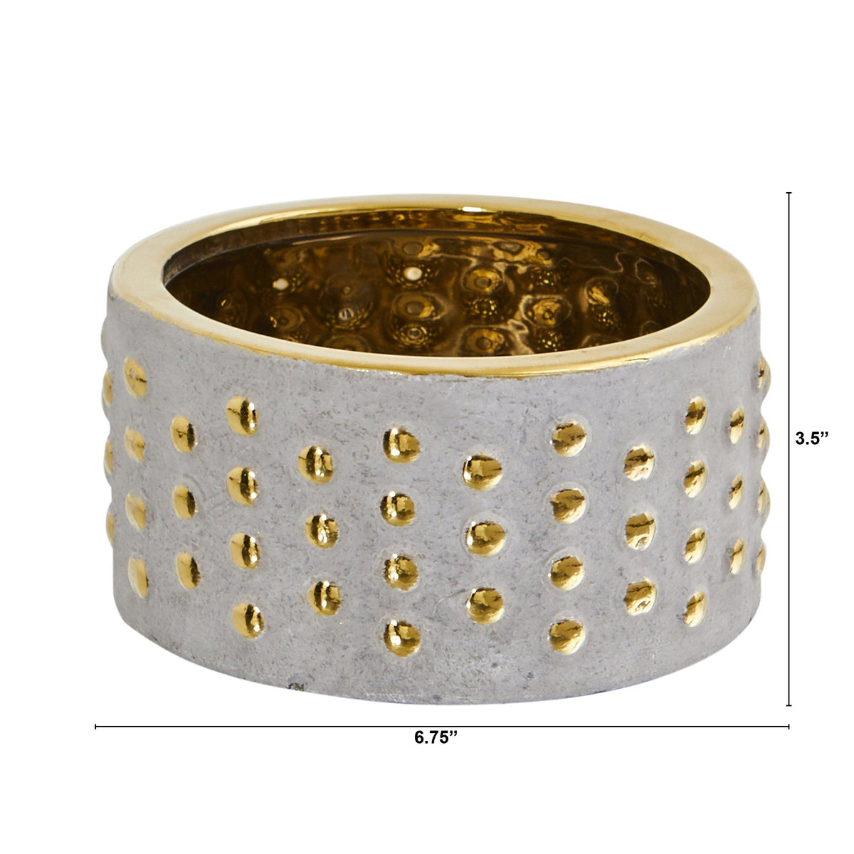 a small round container with gold dots