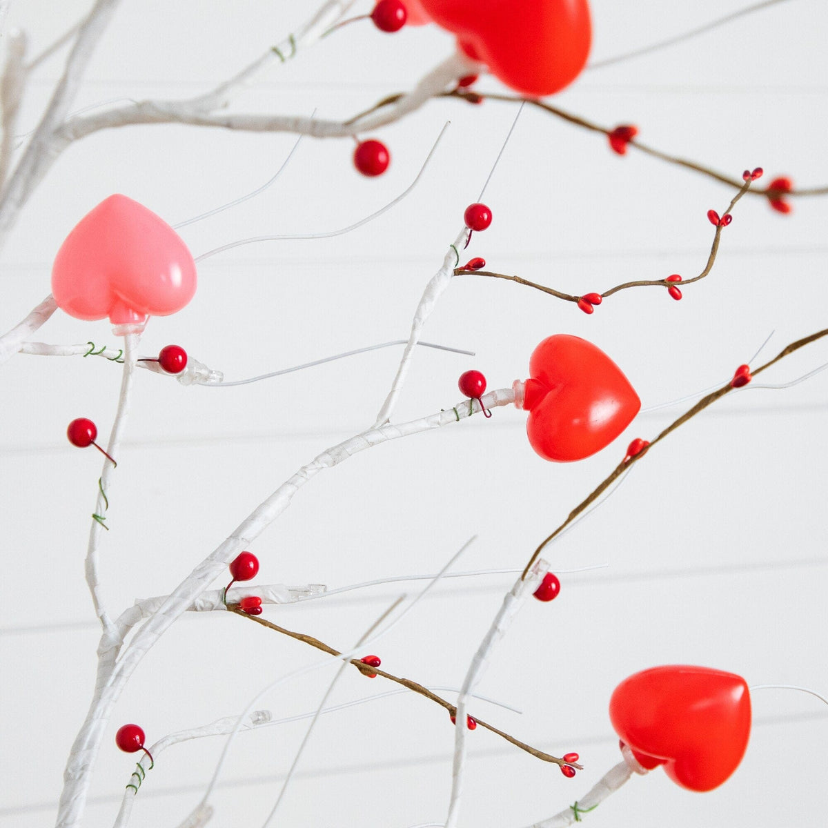 a tree with red hearts and berries