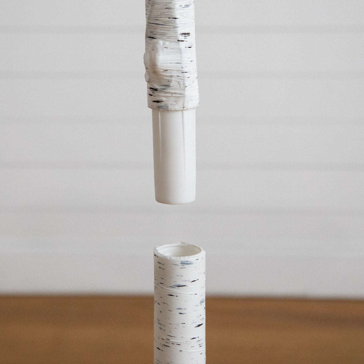 a white tube with a piece of paper