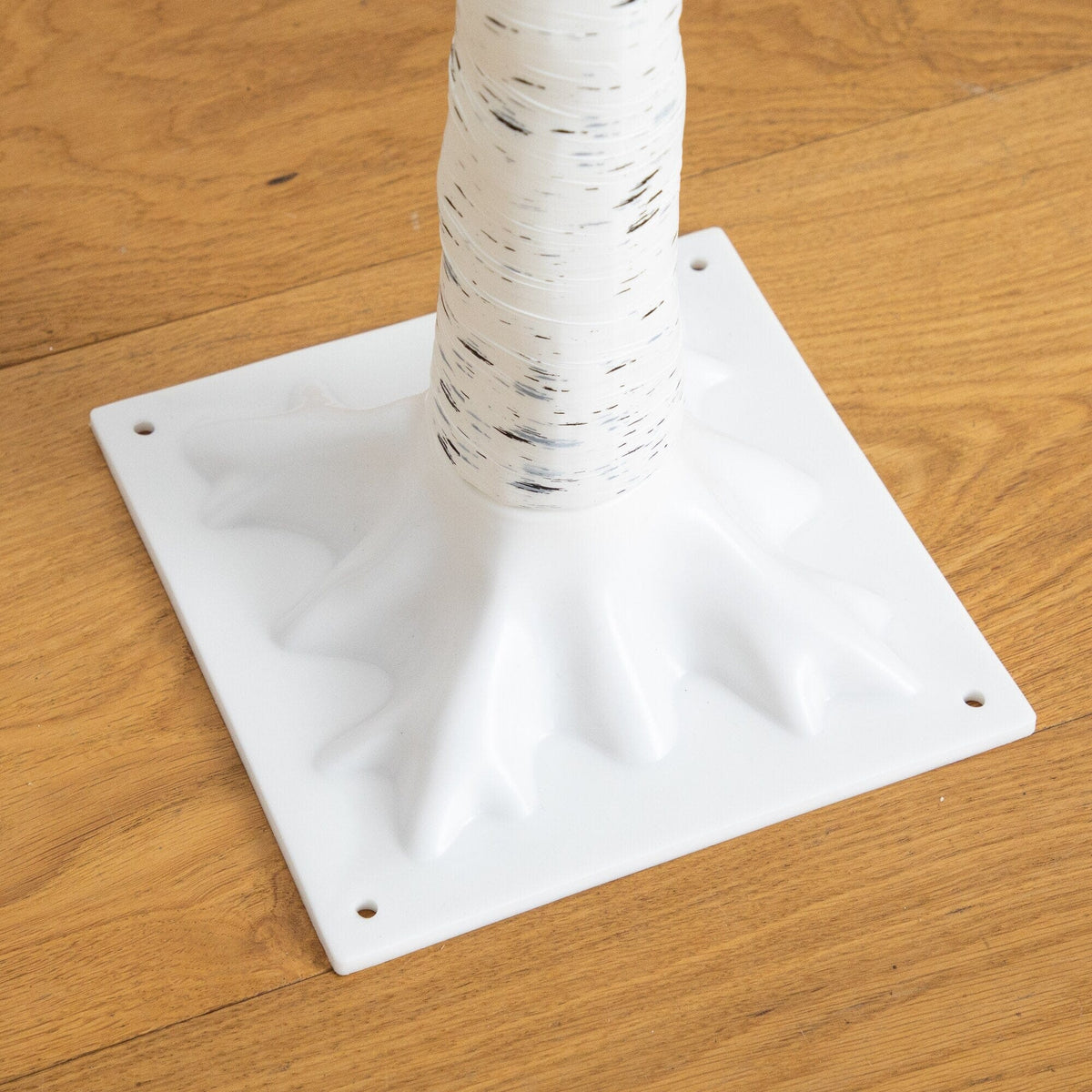 a white plastic base with a black and white pole