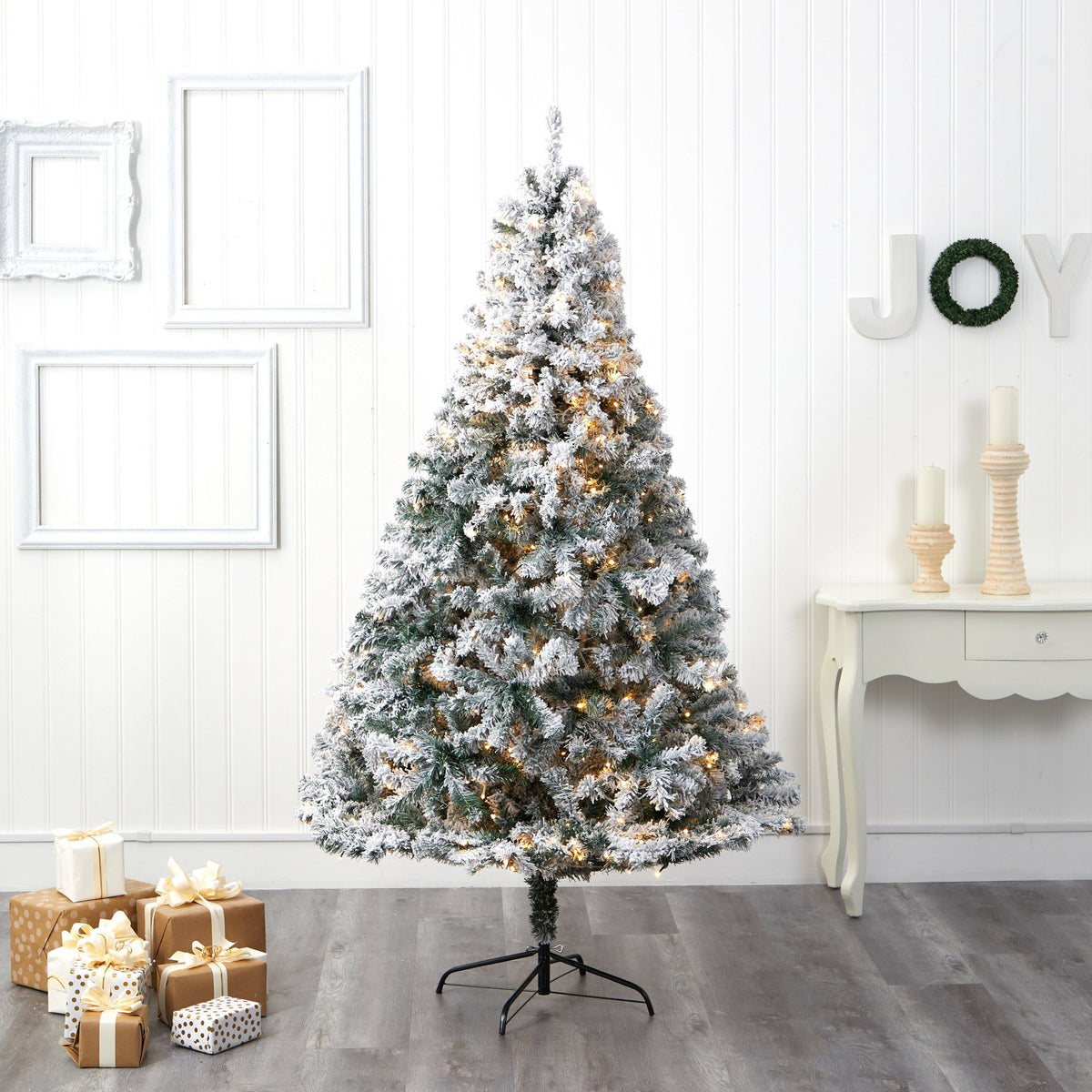 a christmas tree with presents in a room