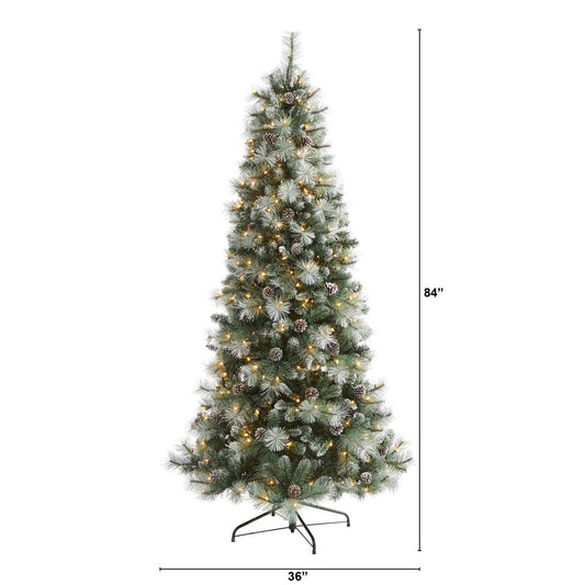 a tall christmas tree with lights and snow