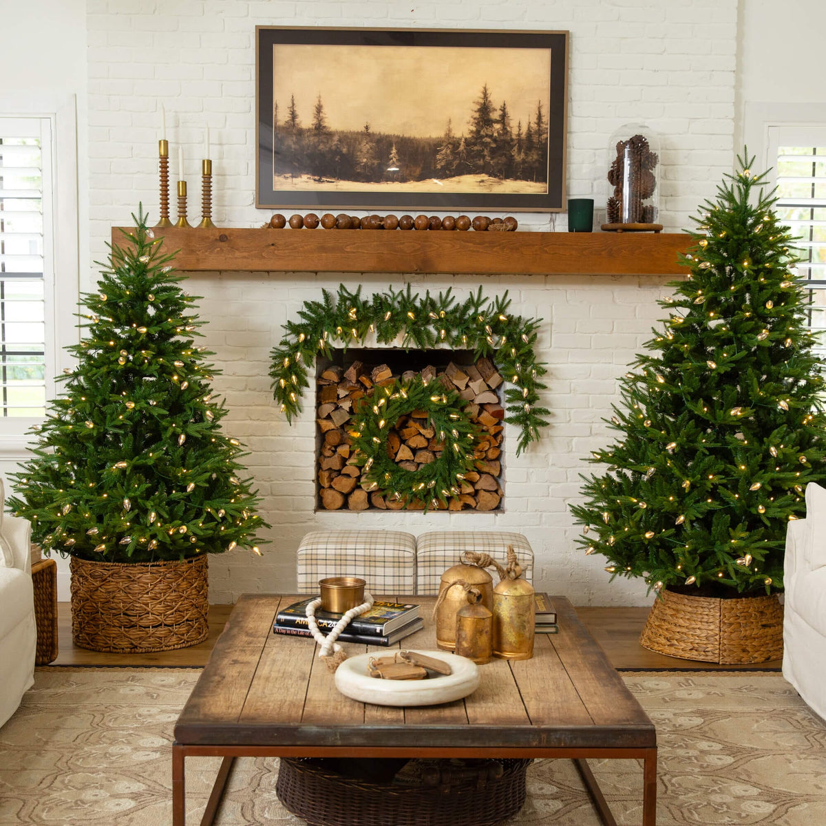 a living room with christmas trees and a fireplace