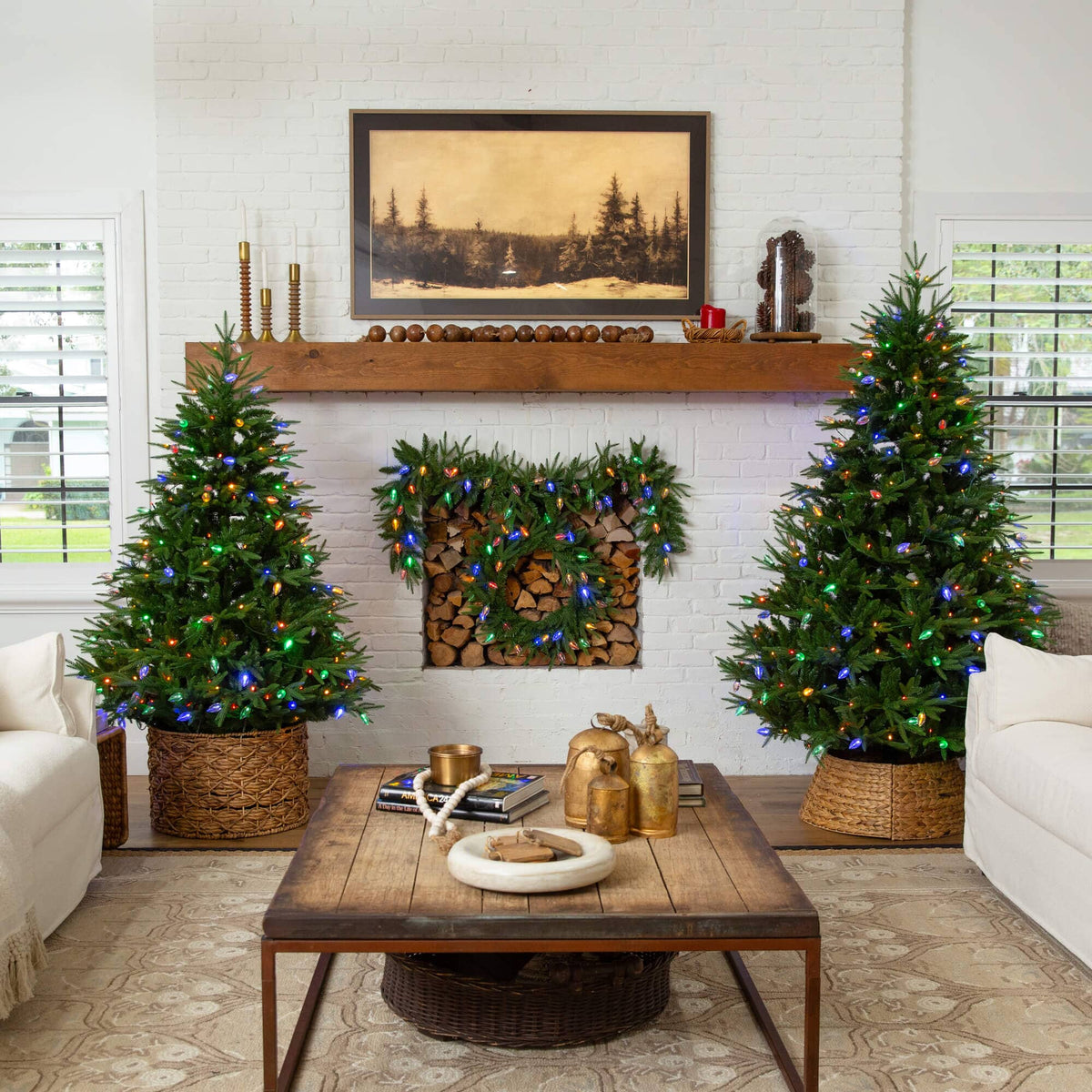 a living room with christmas trees and a fireplace