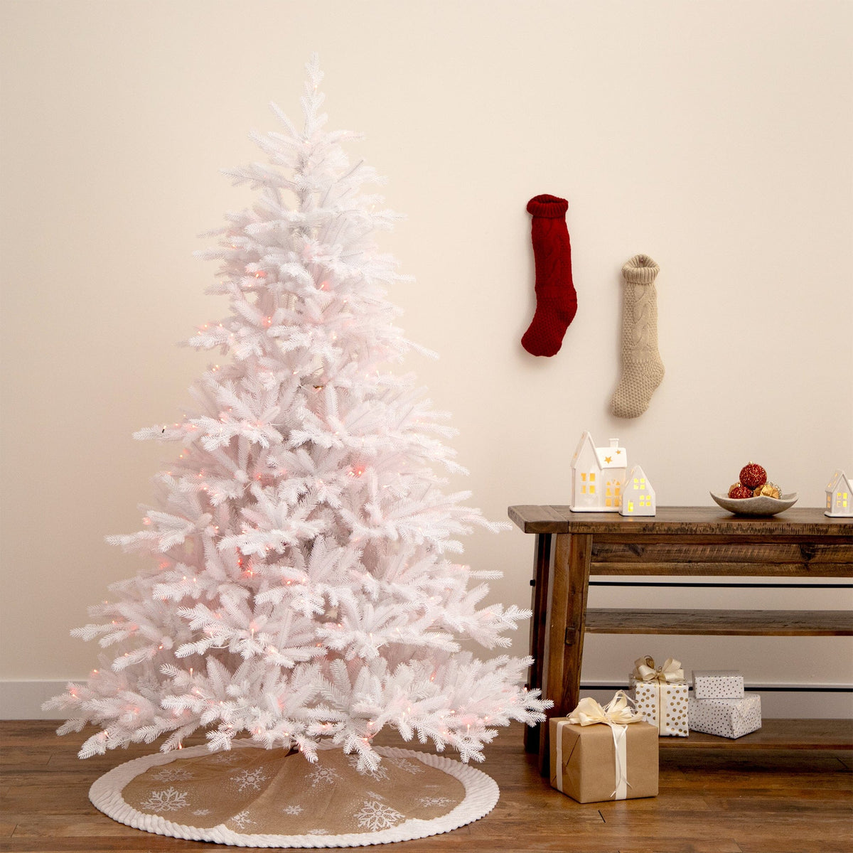 a white christmas tree with lights and presents