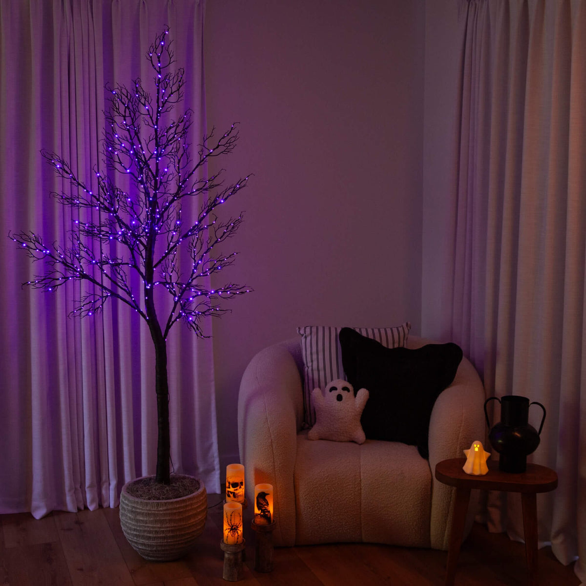 a purple lighted tree in a room