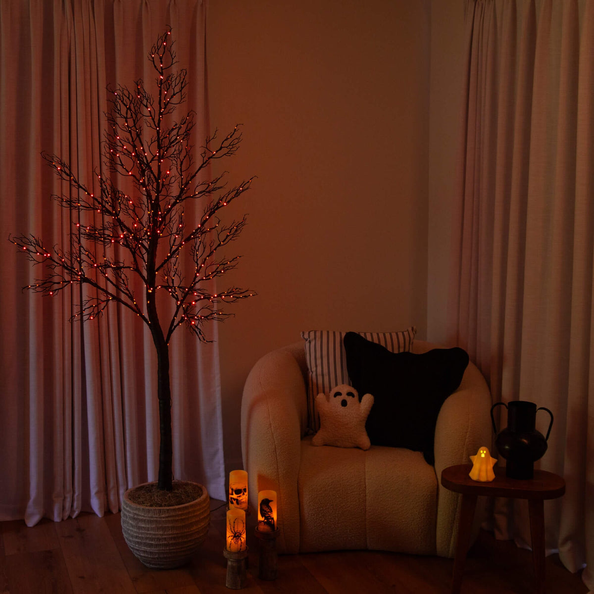 a tree in a room with a candle and a tree