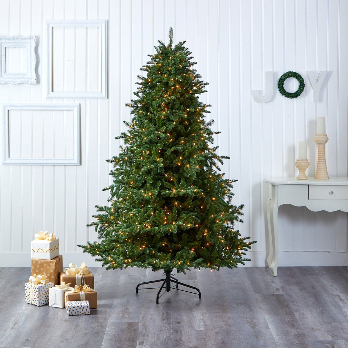 a christmas tree with presents in a room